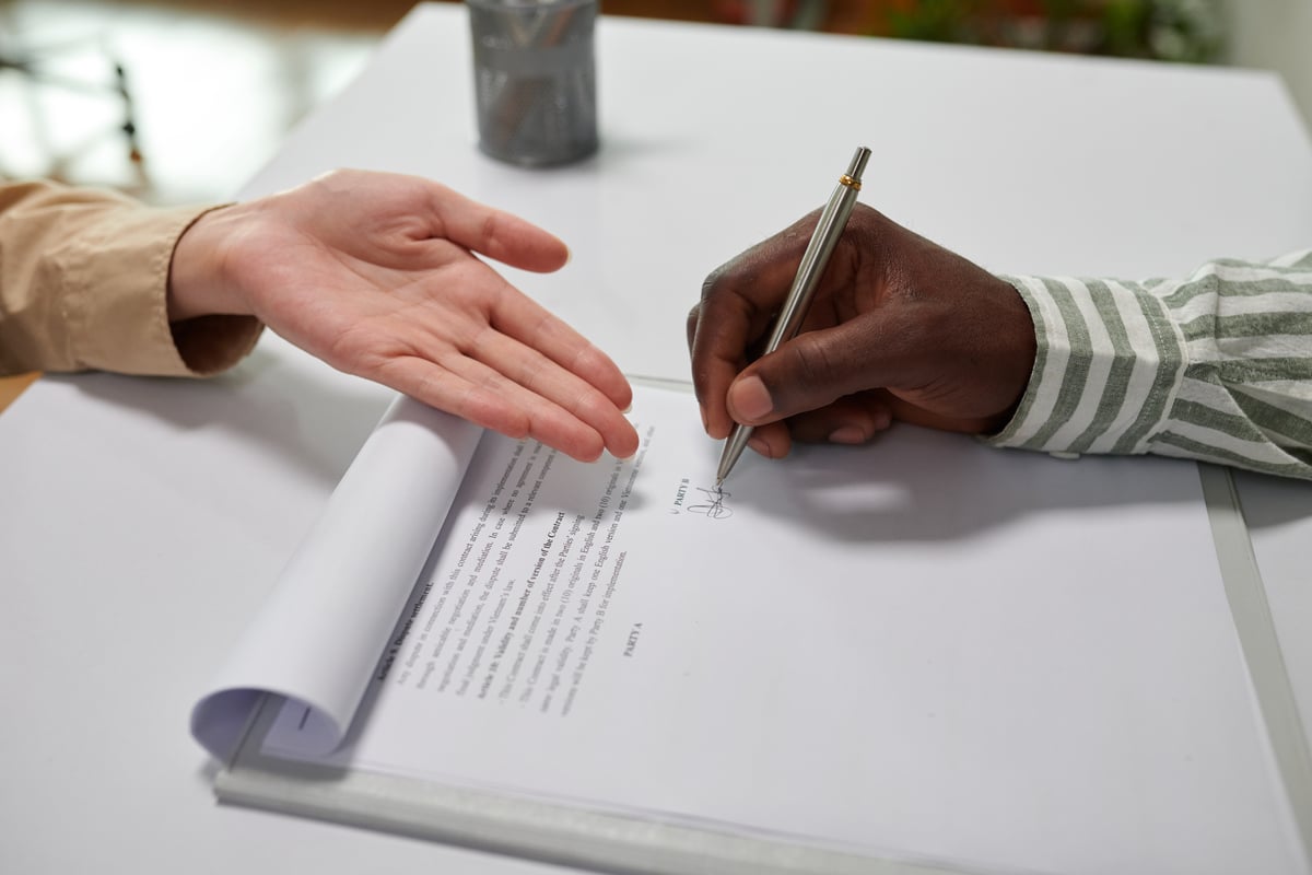 Someone signing an agreement