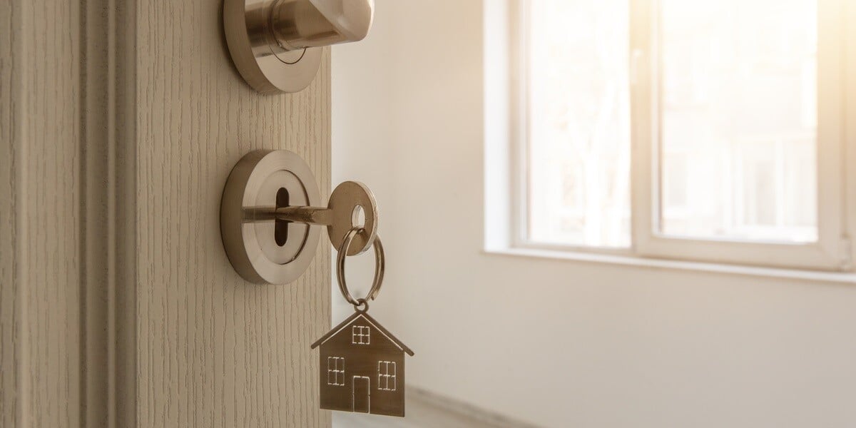 An open door to a property with a key