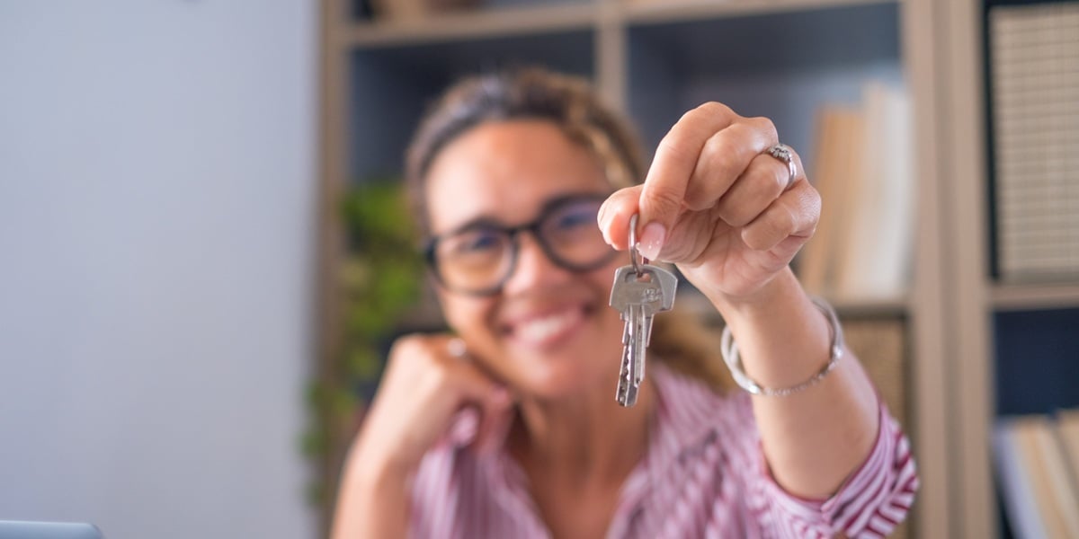 A happy tenant holding rental property keys