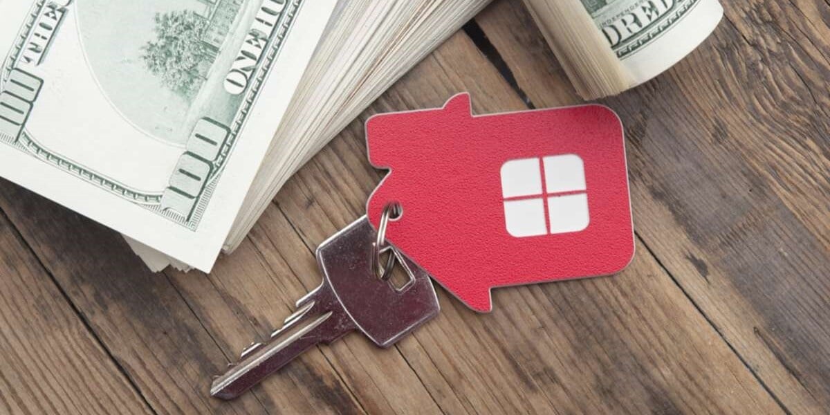 A house key on a stack of cash, cash home buyers - featured_image