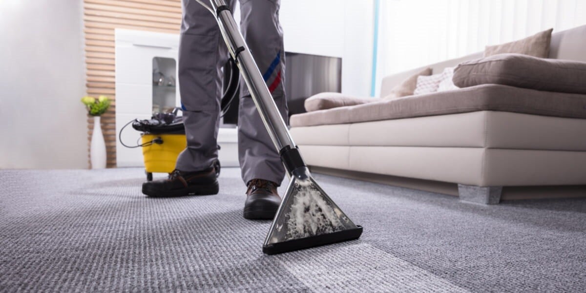 A person using a carpet cleaner