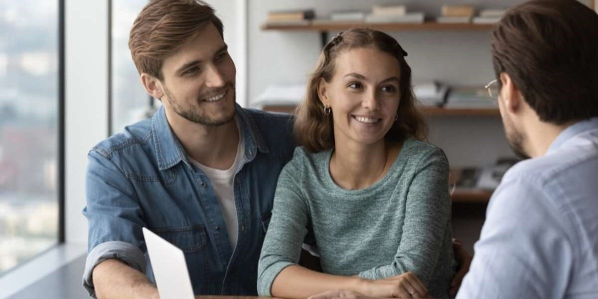 Happy tenants sign a lease with a property manager