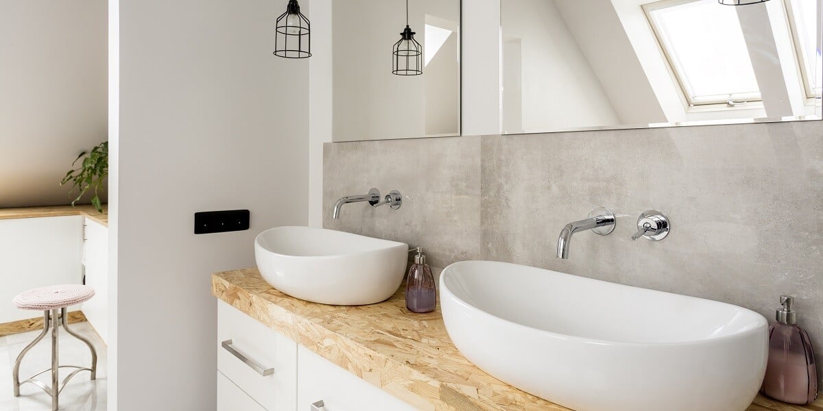 Minimalist bathroom with two sinks and wooden vanity top