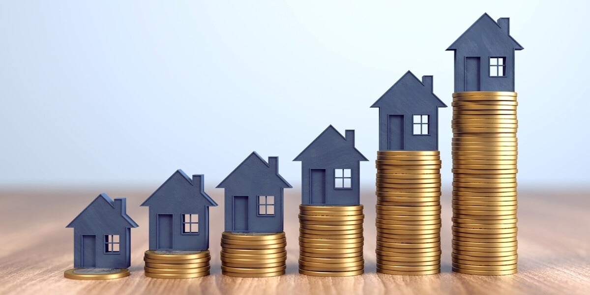 houses on rising stacks of coins illustrating ROI impact - featured_image