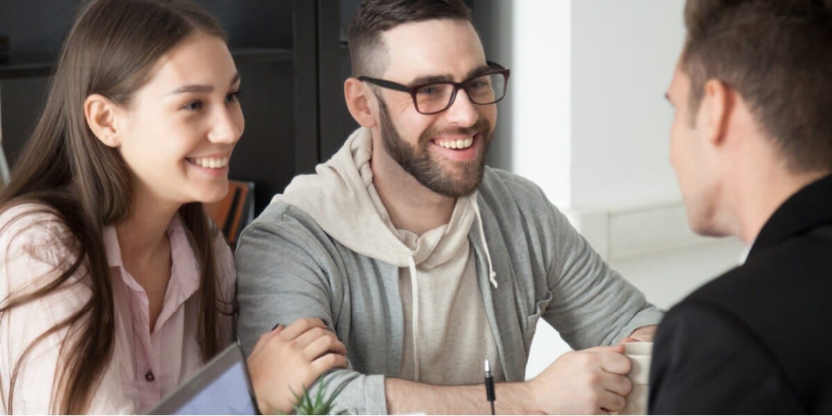 landlord talking with smiling tenants - featured_image